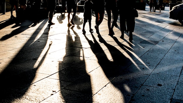 Photo low section of people walking on street in city