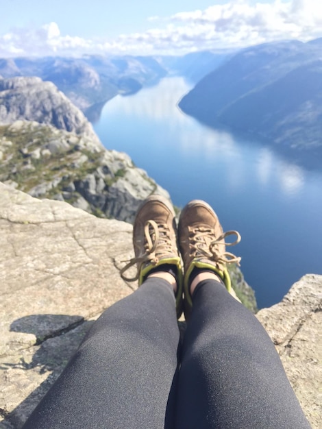 Low section of woman against lake