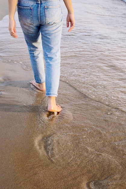 Photo low section of woman walking on beach