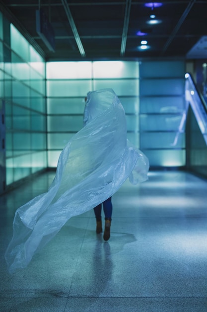 Photo low section of young woman holding plastic on floor