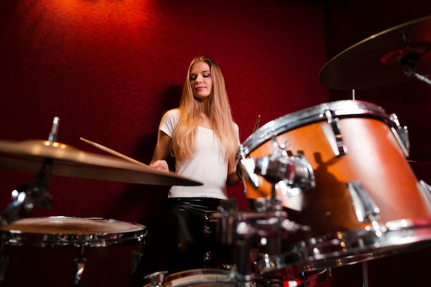 Low view shot of girl playing drums