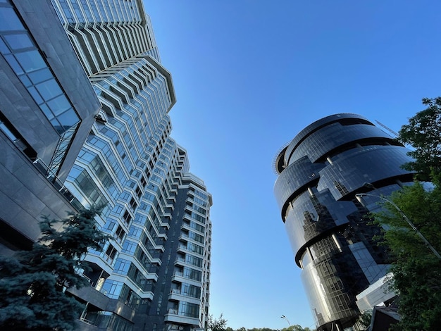 Low wide angle shot of a black glass skyscraper and modern apartment building in the city