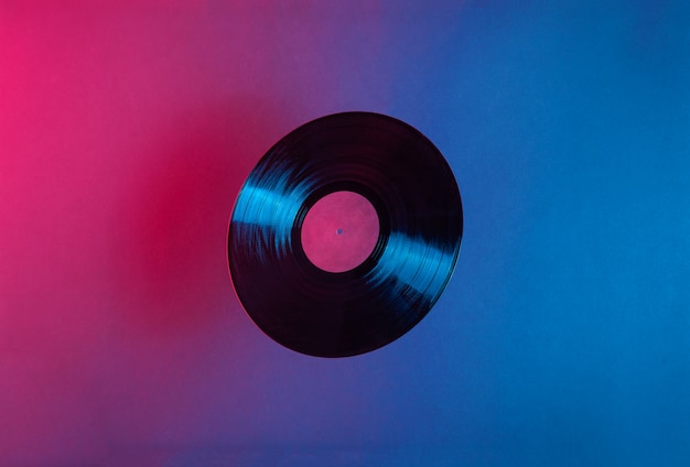 LP vinyl record lit with blue and red colorful neon light