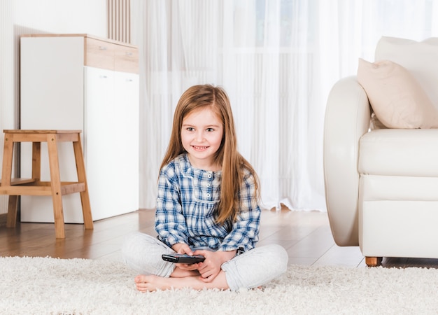 Lttle girl joyfully holding joystick