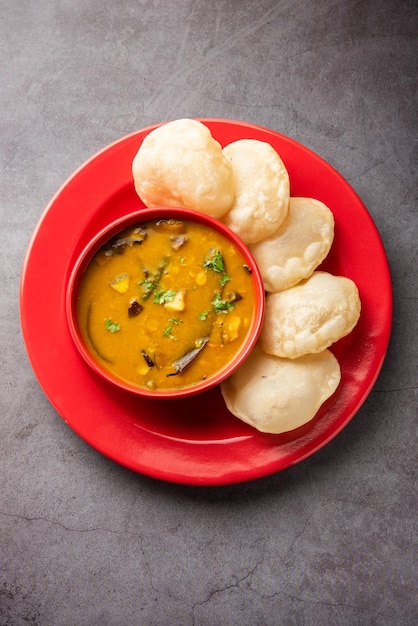 Luchi Cholar Dal or Fried bread made of flour served along with curried Chana or Bengal gram