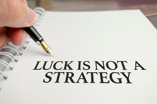 Luck is not A Strategy words with pen and paper