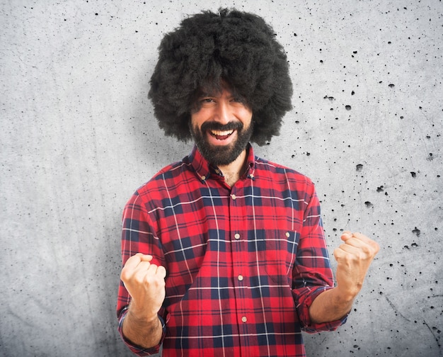 Lucky afro man over white background