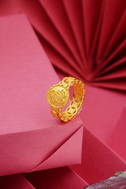 Lucky gold ring on red background