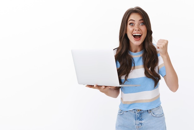 Lucky optimistic good-looking woman watching favorite team game online stream, raise fist pump celebrating