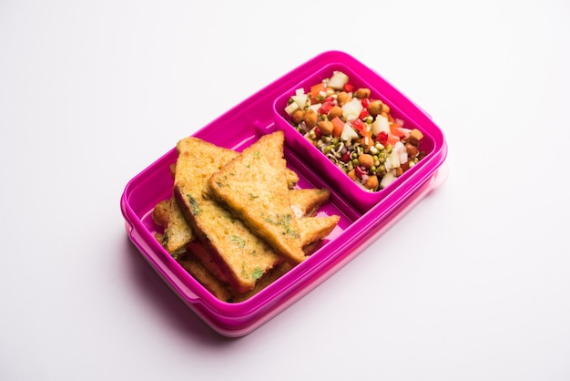 Lunch Box or Tiffin for Indian kids, includes bread Omelette pakora with tomato ketchup or sprouts, selective focus