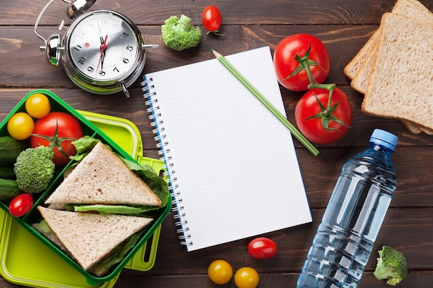 Lunch box with vegetables and sandwich