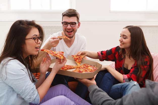 Lunch delivery. Happy people eating pizza at coworking office during break