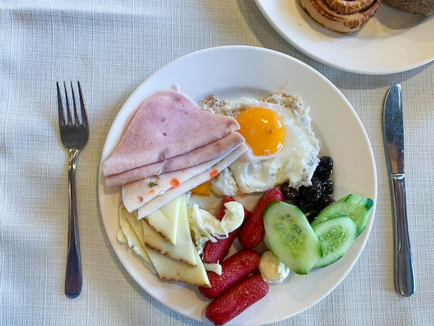 Lunch Plates of eggs ham cheese and vegetables on table Studio Photo