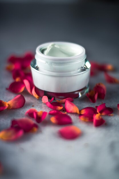 Luxe face cream and rose petals cosmetics with flowers styled beauty concept