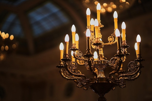 Luxurious antique bronze chandelier with crystal and monograms