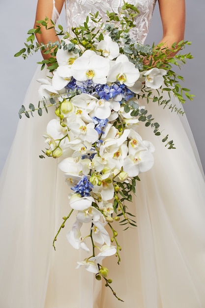 Luxurious bouquet of the bride from orchids and hydrangeas close-up