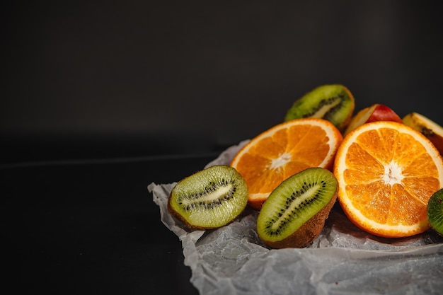 Luxurious fruit backgroundOrange and kiwi in a cut Studio photography of various fruits isolated on black background Copy space high resolution product