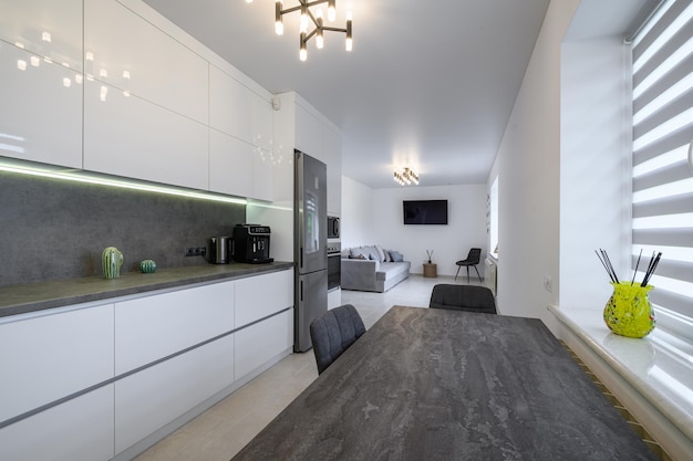 Luxurious white kitchen with granite counter top