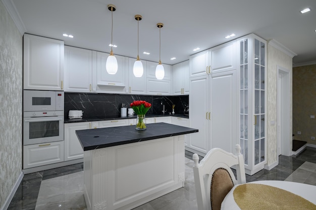 Luxurious white modern domestic kitchen with black marble worktop