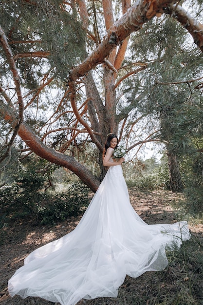 Luxurious young bride in an expensive fashionable wardrobe poses for a wedding photo shoot in a luxury resort town