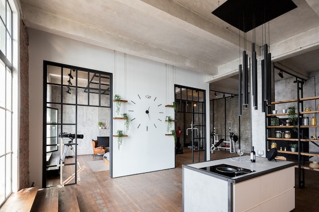 Luxury apartment in a loft style in dark colors. Stylish modern kitchen area with an island