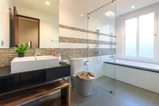 Luxury bathroom features basin, toilet bowl and bathtub