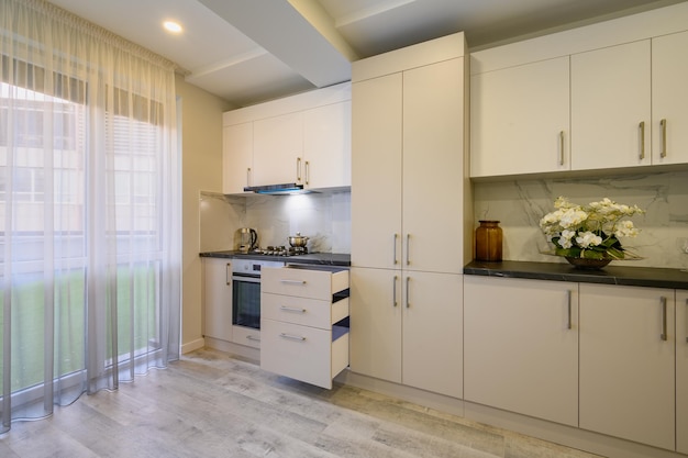 Luxury beige and cream kitchen interior details some drawers retracted