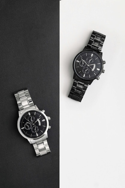 Luxury black and silver watch on black and white table area Monochromatic concept Complementary co