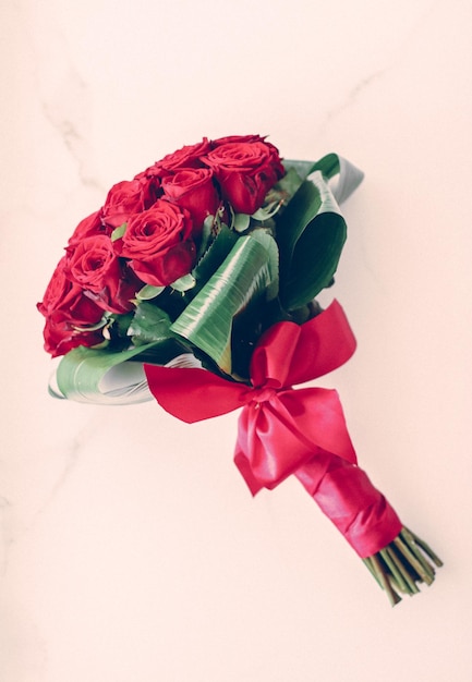 Luxury bouquet of red roses on marble background beautiful flowers as holiday love present on Valentines Day