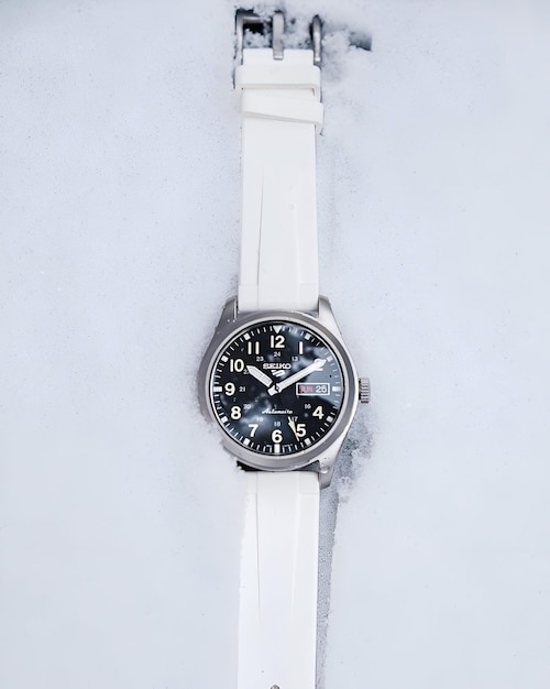 Photo luxury classic analog watch with a white color rubber strap or band side on white background