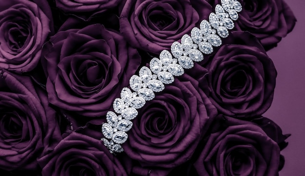 Luxury diamond jewelry bracelet and purple roses flowers love gift on Valentines Day and jewellery brand holiday background design