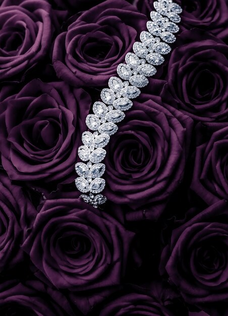 Luxury diamond jewelry bracelet and purple roses flowers love gift on Valentines Day and jewellery brand holiday background design