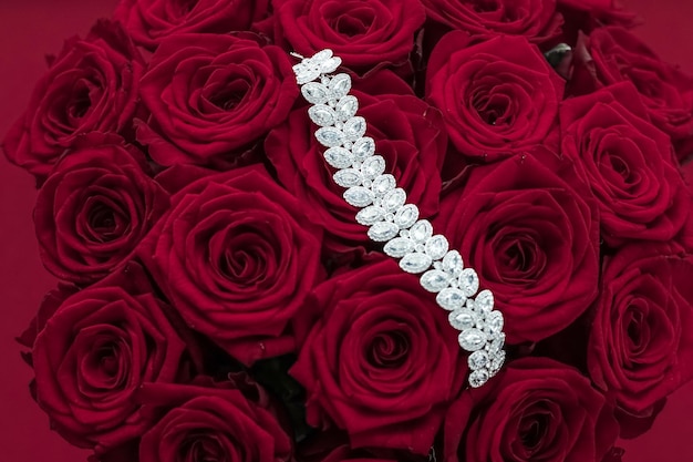 Luxury diamond jewelry bracelet and red roses flowers love gift on Valentines Day and jewellery brand holiday background design