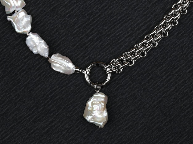 Luxury elegant baroque pearl necklace with pendant on black textured background. Close-up shot