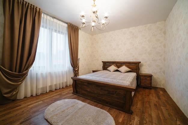 Luxury empty bedroom at home flat or hotel Wooden floor walls Lighting equipment hanging on ceiling