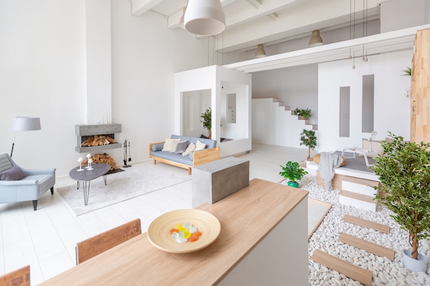 Luxury fashionable modern design apartment with a free layout in a minimal style. very bright huge spacious room with white walls and wooden elements.