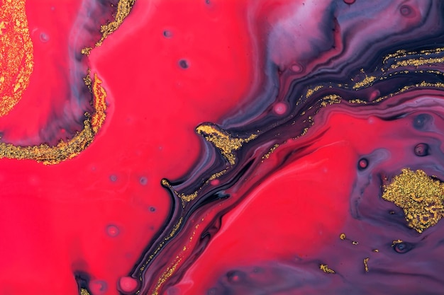 Luxury fluid art painting background. Spilled black, red, blu and gold acrylic paint.  Liquid marble pattern. Alcohol ink splash.