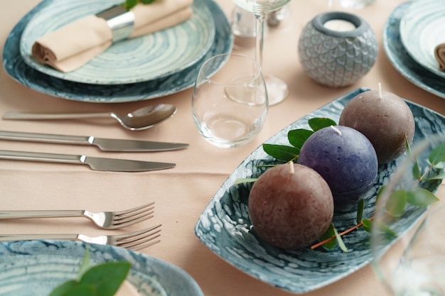 Luxury green table setting decorated with candles