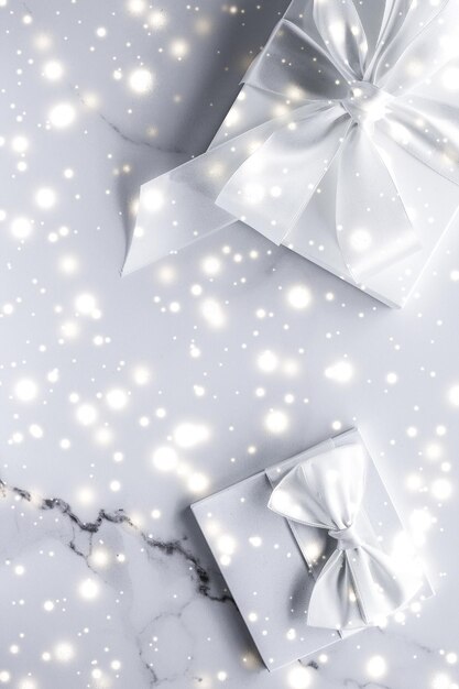 Luxury holiday gifts with white silk bow and ribbons on marble background Christmas time surprise