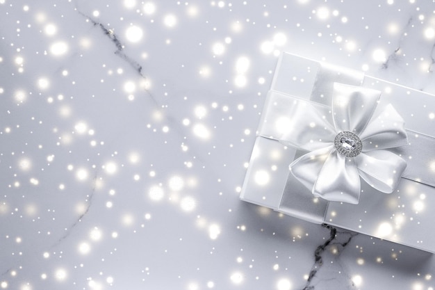 Luxury holiday gifts with white silk bow and ribbons on marble background Christmas time surprise