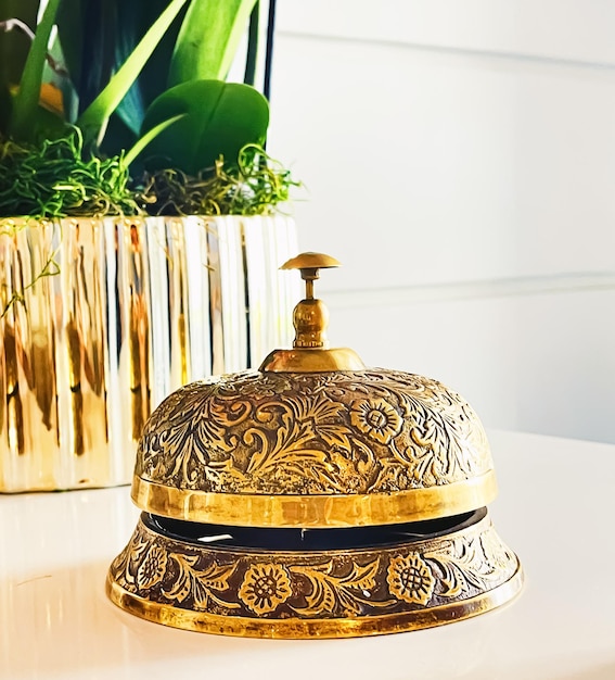 Luxury hotel and five stars room service golden vintage reception bell for travel and hospitality