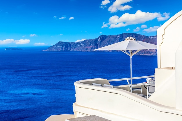 Luxury hotel in Oia Santorini Greece Iconic image of vacation in Greece with sea and umbrella