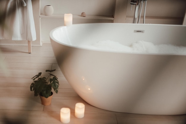 Luxury interior of big bathroom at modern african style with oval bathtub in natural lighting