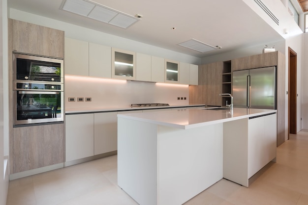 Luxury interior design in kitchen area which feature island counter and built in furniture