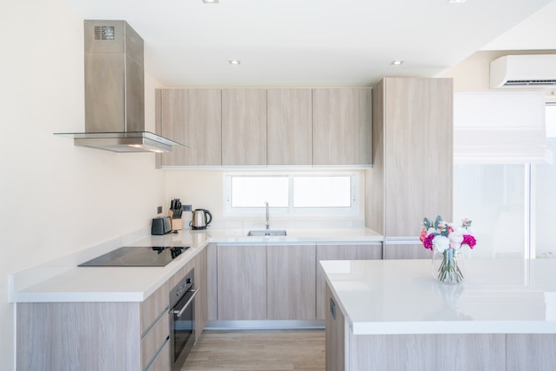 Luxury interior design pool villa in kitchen area which feature island counter and built in furniture