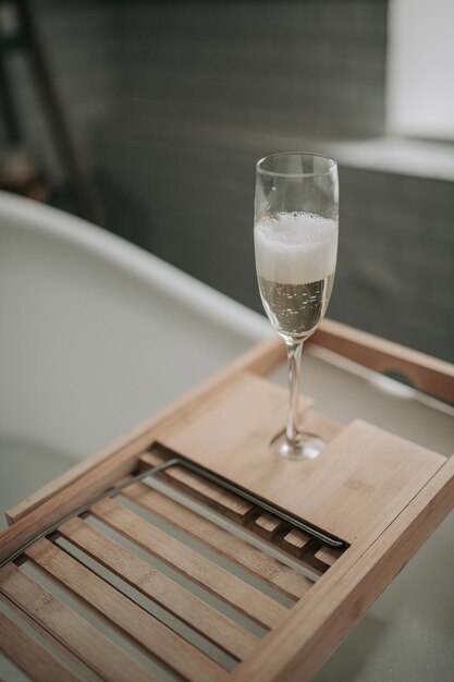 Luxury interior eco style modern bathroom with oval bathtub and champagne glass at natural lighting