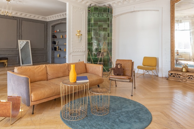 Luxury interior of a spacious apartment in an old 19th century historical house with modern furniture. high ceiling and walls are decorated with stucco