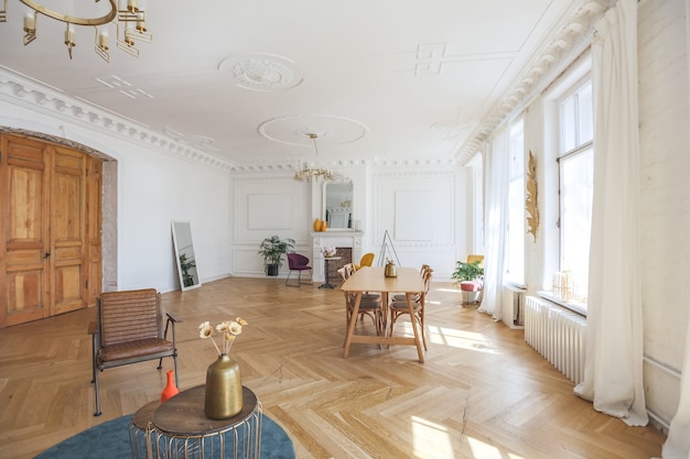 Luxury interior of a spacious apartment in an old 19th century historical house with modern furniture. high ceiling and walls are decorated with stucco