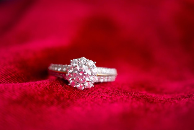 Luxury jewelry diamond ring on red fabric background