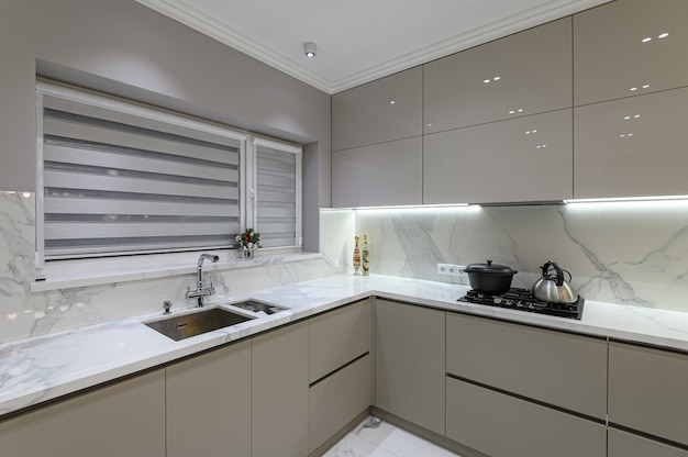 Luxury large modern white marble kitchen united with dining room